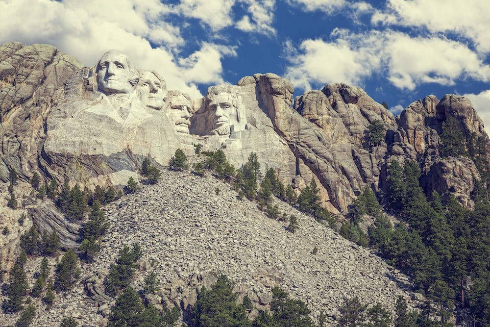 Wide shot of Mount Rushmore located in the Black Hills of South Dakota